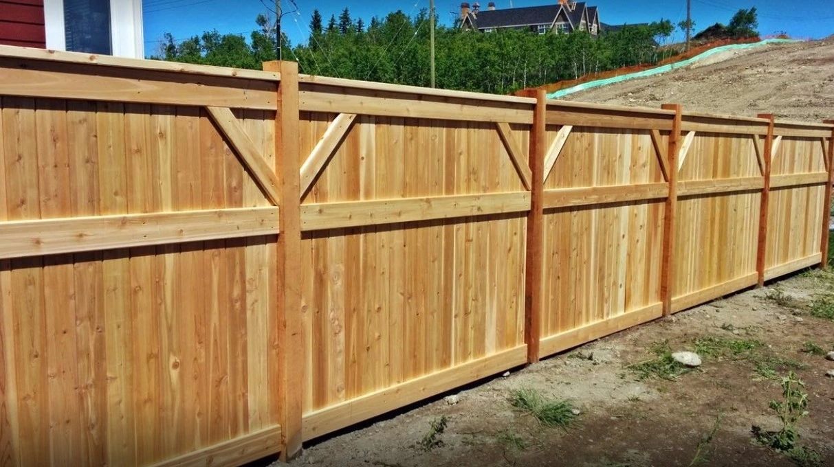 Cedar cap-and-trim wood privacy fence built by Working With Wood